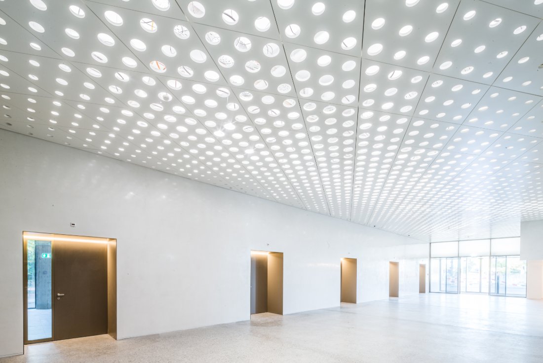 Daylit hall with a luminous perforated ceiling, Grosspeter, Basel